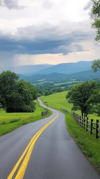 Winding road through scenic valley, mountains backdrop, rural landscape, travel photography.