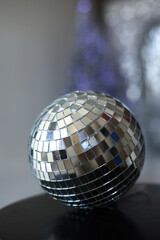 Disco ball on a blue background with shadows and highlights of bright sunlight. Abstract holiday background.