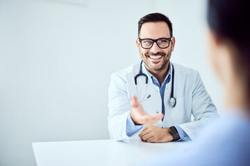 Smiling Doctor Offering Assistance During a Professional Consultation at a Clinic