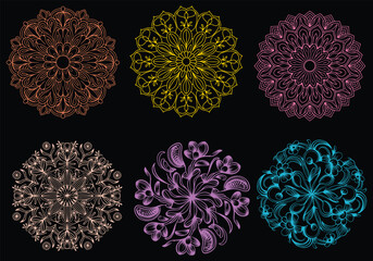 An elaborate black and white mandala illustration with a radial floral pattern. The illustration has a high contrast and strong, bold outlines. The pattern is filled with various flowers