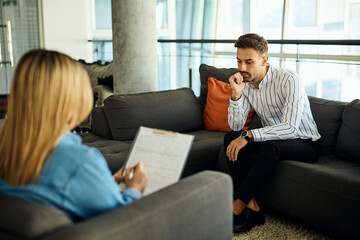 Man Attentively Listening During a Professional Counseling Session in a Modern Office Setting