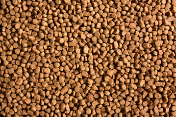 Dry pet food background. Pile of granulated animal feeds. Granules of good nutrition for dogs and cats.