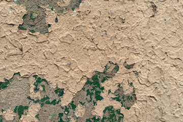 Wall of an old building, peeling beige paint with cracks, layers of old paint. Texture of old painting, background, backdrop, desktop, screen.