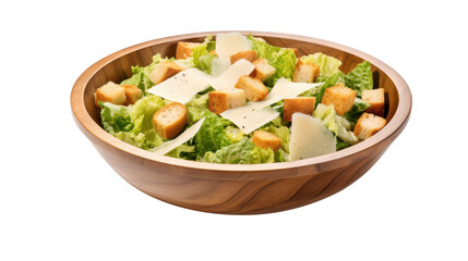 Crisp green lettuce leaves topped with crunchy croutons and shaved cheese are beautifully presented in a round wooden bowl against a white background