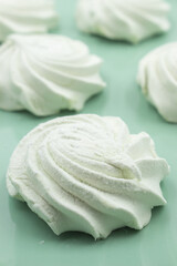 Light green apple marshmallows on a light green plate, close-up
