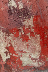 Aged Red and Beige Textured Wall Surface with Peeling Paint Patterns