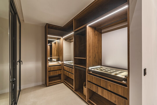 a close up image of a newly installed illuminated walk in wardrobe in luxury mediterranean real estate