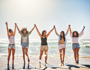 Obraz premium Friends, celebration and women holding hands at beach with holiday freedom, summer adventure and excited. Sky mockup, people and happy by ocean together for seaside fun, tropical vacation and support