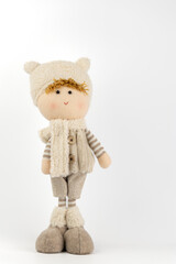 close-up on white background there is a toy under the Christmas tree, a boy in beige clothes, a hat...