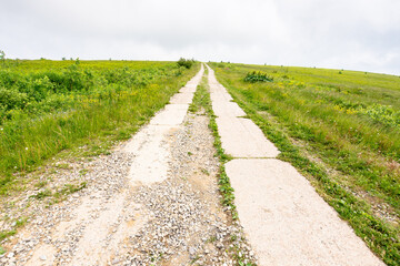 old concrete mountain road. highland landscape. path through smooth mount on a cloudy day. travel ukraine. rustic journey to success