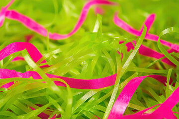 Naklejka premium Vibrant green grass interwoven with bright pink decorative ribbons
