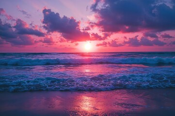 Fototapeta premium Colorful hues of pink, purple, and orange reflect on gentle ocean waves, creating a serene atmosphere during the evening twilight along the coastline.