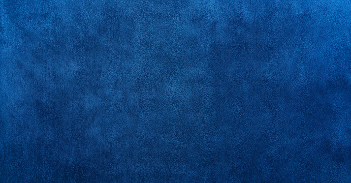 A smooth blue velvet fabric surface with a rich color, perfect for elegant designs or fashion photography. Its luxurious texture adds depth and sophistication, ideal for showcasing softness and qualit