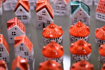 Miniature ceramic houses on a wooden table.