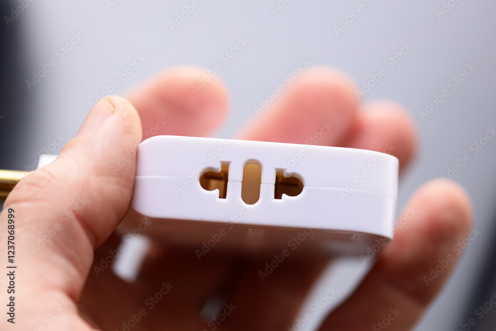 Poster a person holds a white device in their hand, suitable for tech-related and digital concept images.