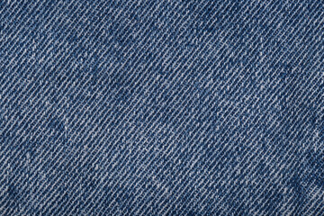 The denim is light blue. Denim background.