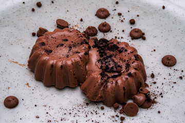 This delightful image showcases a rich chocolate dessert on a plate. The smooth texture and crumbled topping invite indulgence and satisfaction.