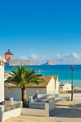 Fototapeta premium Whitewashed houses in Altea old town street with view to Mediterranean sea. Architecture in small picturesque Altea town, Alicante province, Valencia Community, Spain