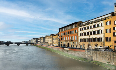 The Ponte Vecchio, Old Bridge, a Medieval stone closed-spandrel segmental arch bridge over the Arno...