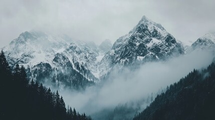 Fototapeta premium Majestic snow capped mountains shrouded in mist