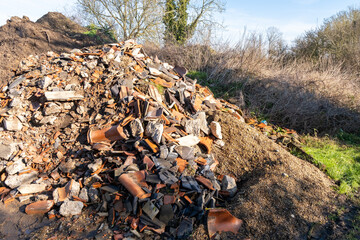 A pile of demolition waste fly tipped in the countryside