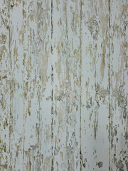 Close-up of a distressed wood surface with the texture of old peeling paint. This texture is ideal for backgrounds, banners or rustic designs.