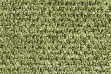Fototapeta premium Texture of khaki jacquard fabric, close up of rough weave macro. Material for home textile, upholstery and curtain decor, garment. Background, wallpaper, backdrop.