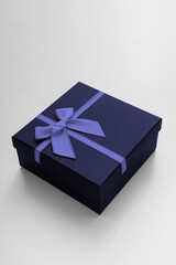 Violet celebrated gift box lie on white background