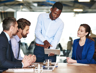 Man, tablet and people in office for meeting, project review and business proposal idea. Male...