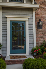 Fototapeta premium Stunning Teal Front Door and Brick House Exterior: Dream Home Entrance