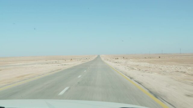 Driving through Saharan desert on a sunny day