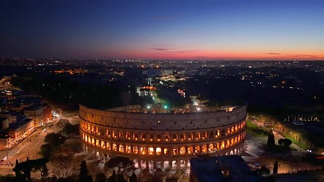 4k Aerial View of Beautiful sunset over the illuminated Colosseum in Roma with a vibrant skyline and city lights. Italy