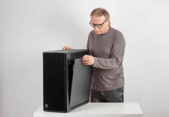 Man removing  metal right  panel  from  PC case, empty big tower, chassis.