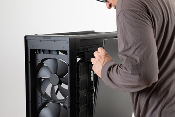 Man removing  metal right  panel  from  PC case, empty big tower, chassis. PC case without top and front panel.