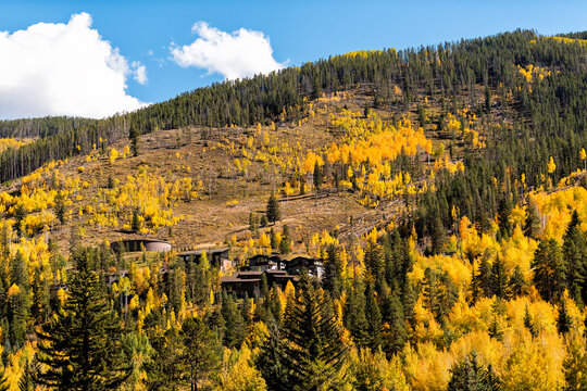Vail Colorado town village in rocky mountains with scenic views of fall autumn golden foliage and house real estate