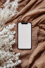 Smartphone with a blank screen on a mocha-toned fabric background