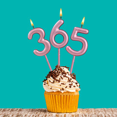 Three candles forming the number 365 - Green background.