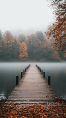 Fototapeta premium Tranquil Wooden Dock in Misty Autumn Landscape by Calm Water