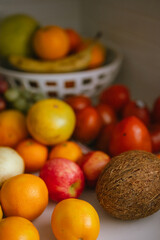 Assorted fresh fruits and vegetables arranged in a kitchen basket