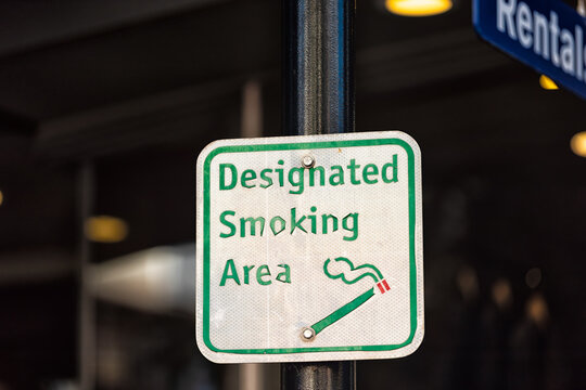 Smoking designated symbol sign in Vail, Colorado village with smoke area zone in ski resort town with symbol of cigarette
