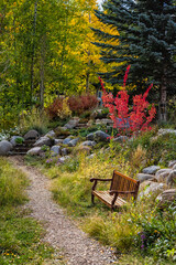 Beaver Creek, Colorado ski resort in autumn fall and bench by aspen trees in park vertical view...