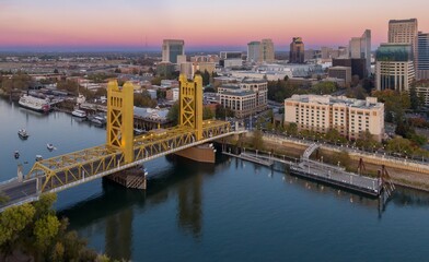 Fototapeta premium Tower Bridge, Sacramento, CA. Aerial view of the city skyline, river, and bridge at sunset. Urban landscape. Tower Bridge, Sacramento, California, USA