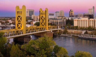 Tower Bridge, Sacramento, CA at sunset. City skyline, river, and pedestrian walkways. Beautiful...