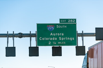 Aurora and Colorado Springs sign in Rocky mountains on Interstate 70 highway road to 282 exit for 225 south street