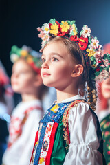 School kids participating in flower themed school play. Cheerful children performing on theater stage in front of their parents. Creative leisure for elementary school students.