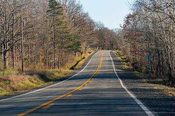 West Virginia rural countryside road highway in autumn fall through Canaan valley forest woods disappearing winding on rolling hills landscape