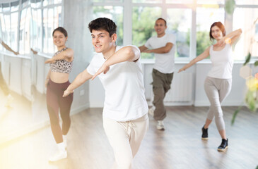 Guy, together with dance youth group, rehearses performance, works out succession of events...