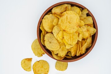 Potato chips with onions, garlic and herbs on a white background.