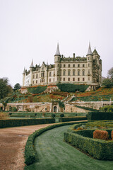 Fototapeta premium Castle in the Scottish Highlands - Majestic French-Style Château with Turrets, Formal Gardens, and Scenic Hilltop Views