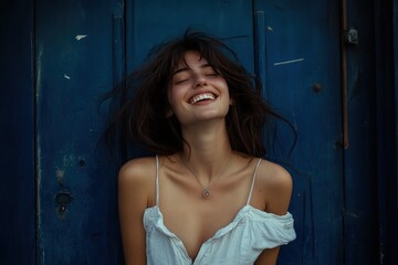 Fototapeta premium Joyful Woman Laughing Against a Blue Door. Generative AI.